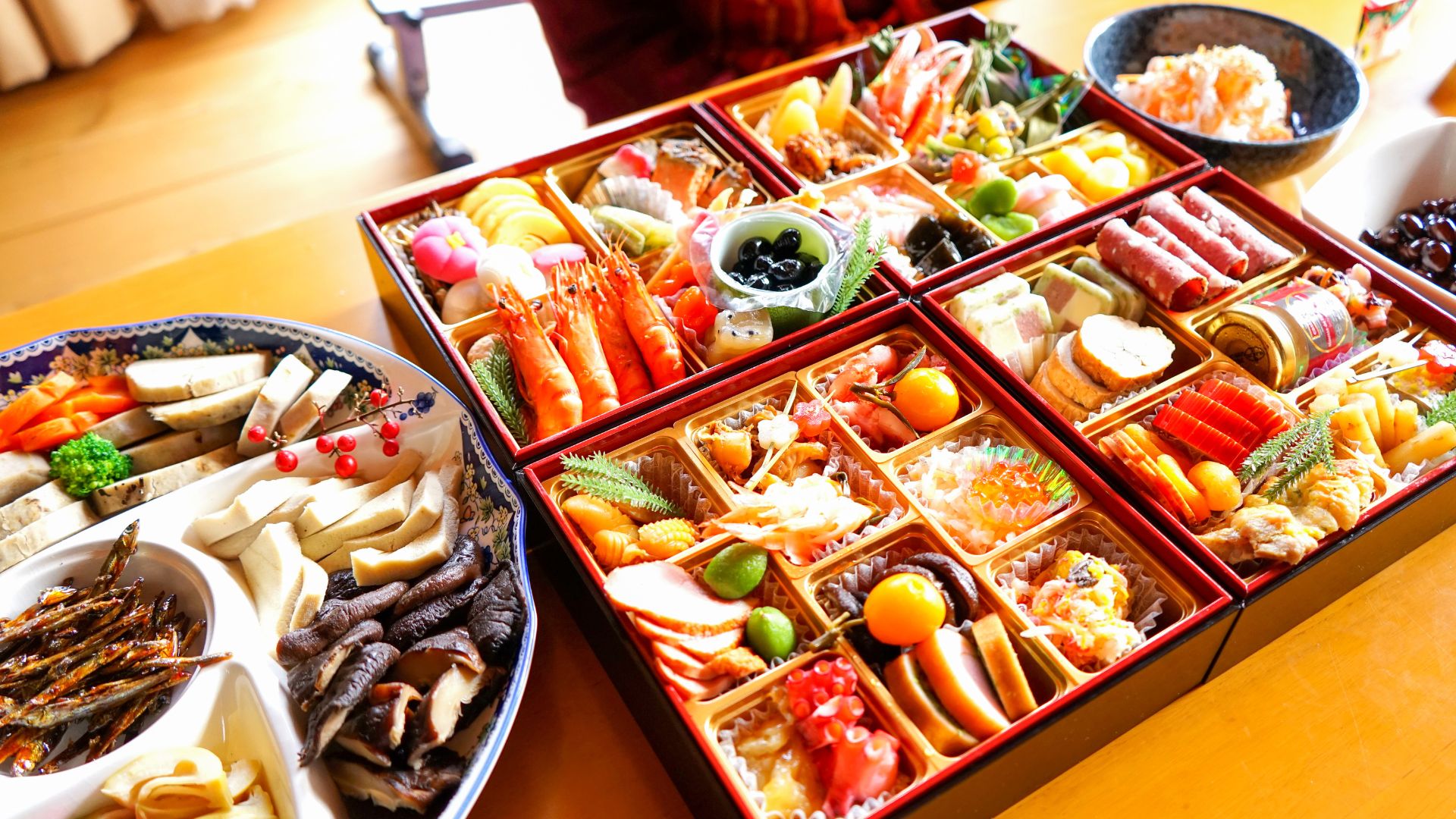 Photo of a traditional Japanese new years meal including a variety of dishes.