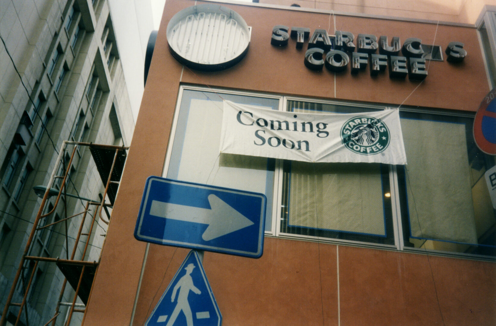 Image of Starbucks' store front with 'coming soon' sign.