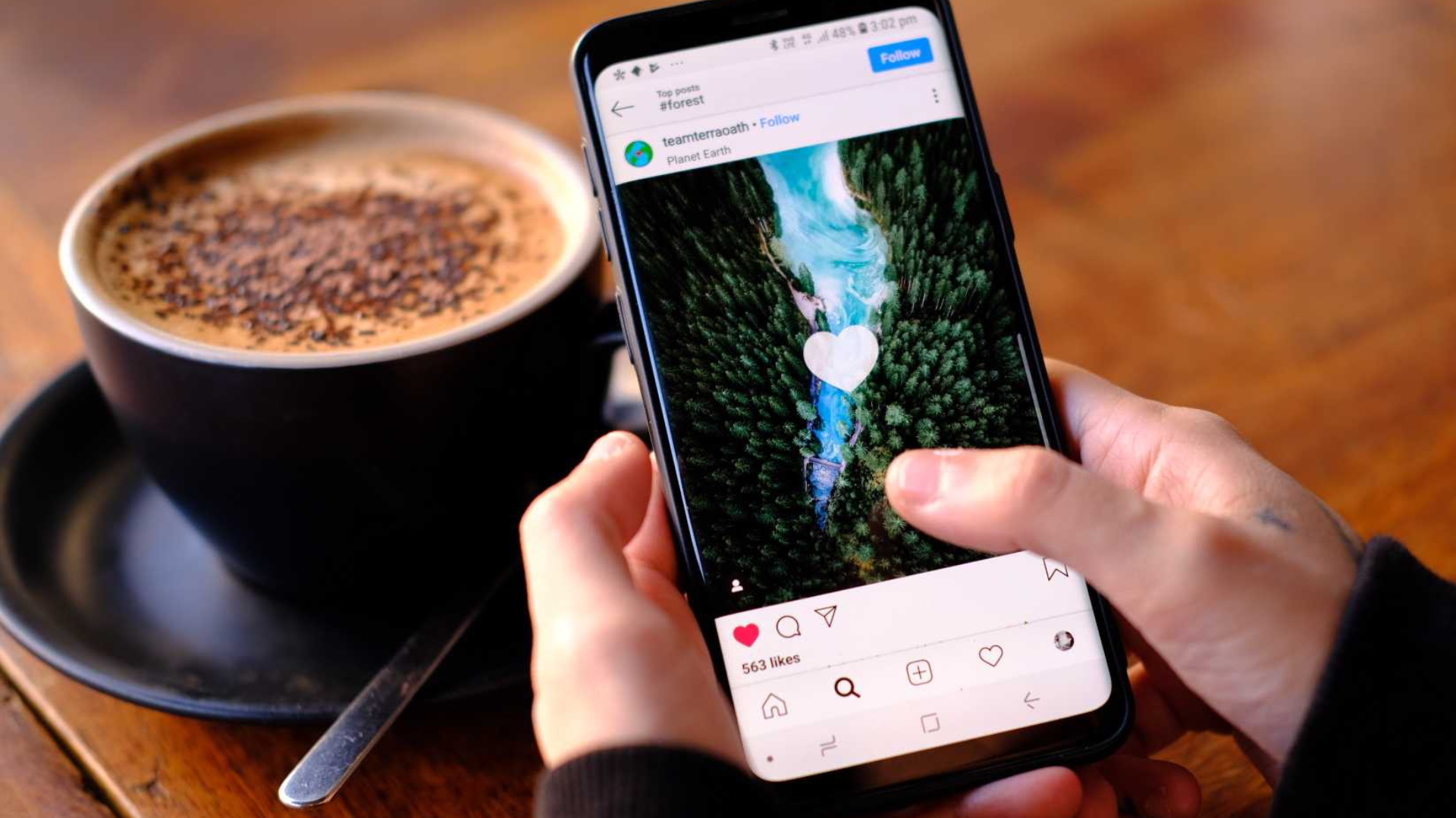 Person liking photo with coffee nearby